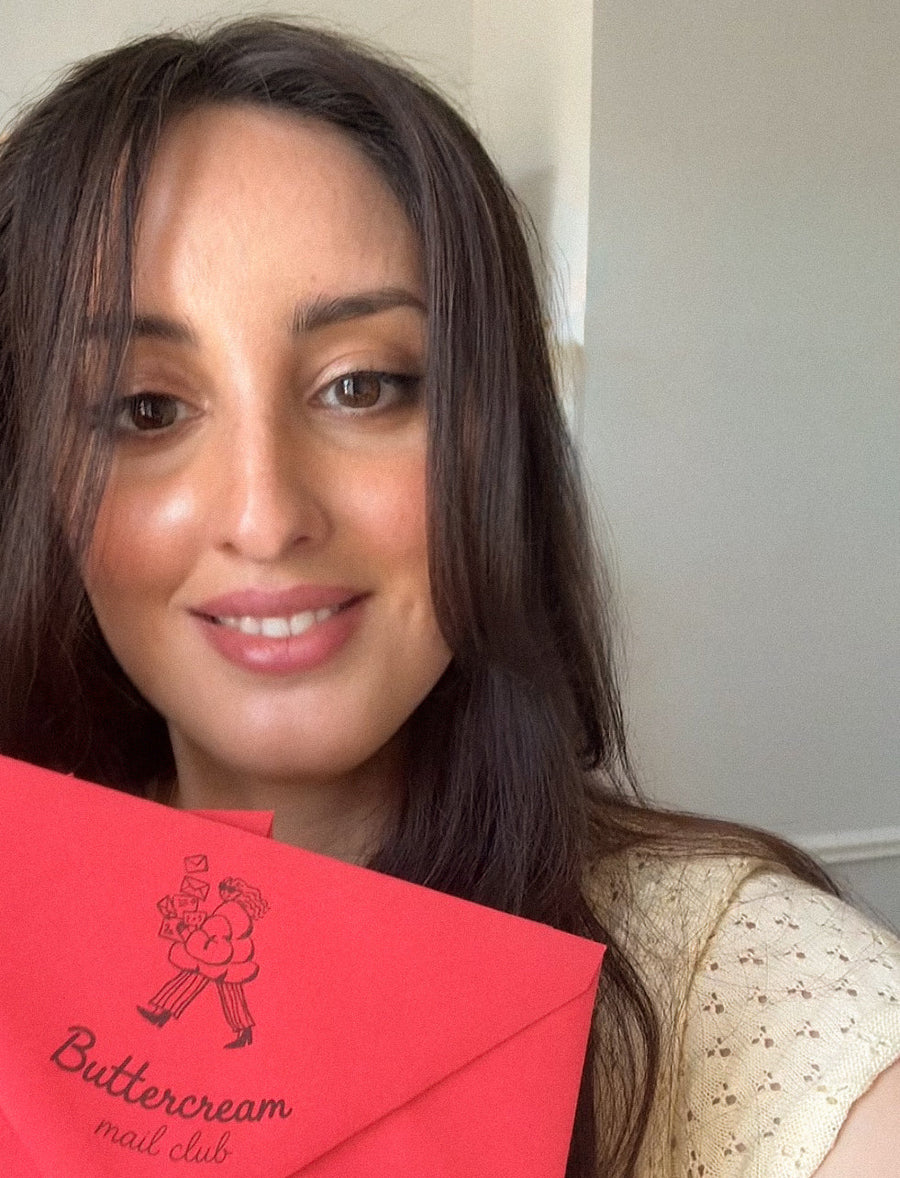 Tracy holding a Buttercream Mail Club envelope.