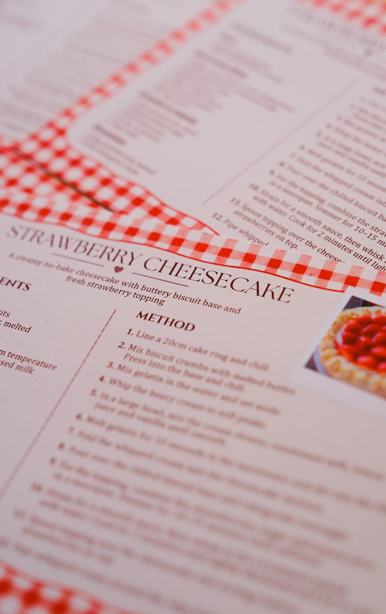 The August 2026 recipe card for no-bake strawberry cheesecake, with ingredients and numbered method.