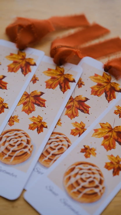 The September 2026 illustrated bookmark with autumn maple leaves and an orange chiffon ribbon, this month's surprise insert.