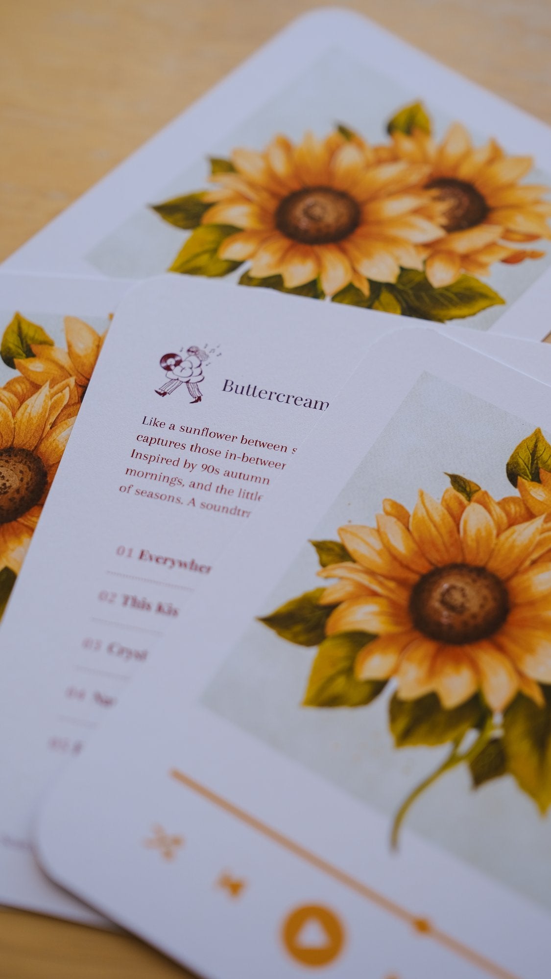 Close-up of the September 2026 playlist card with its sunflower illustration and track list.
